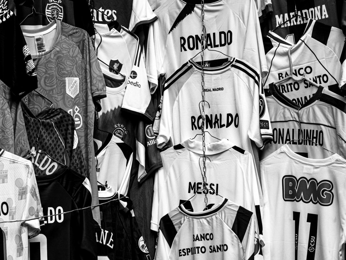 A rail of archived football shirts in a collectibles store